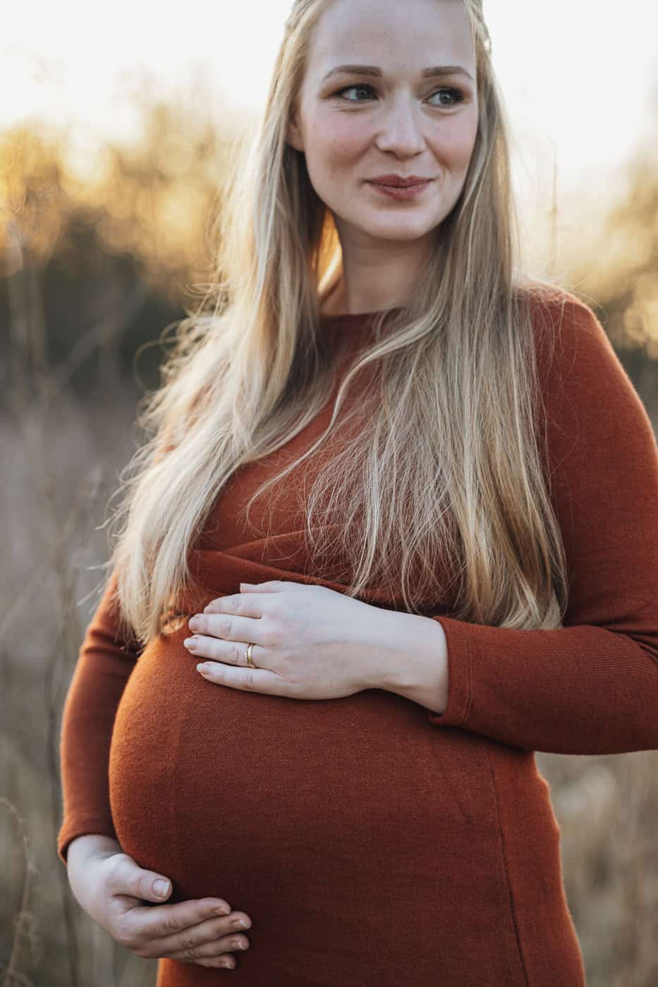 Babybauch Shooting romantisch im Sonnenuntergang